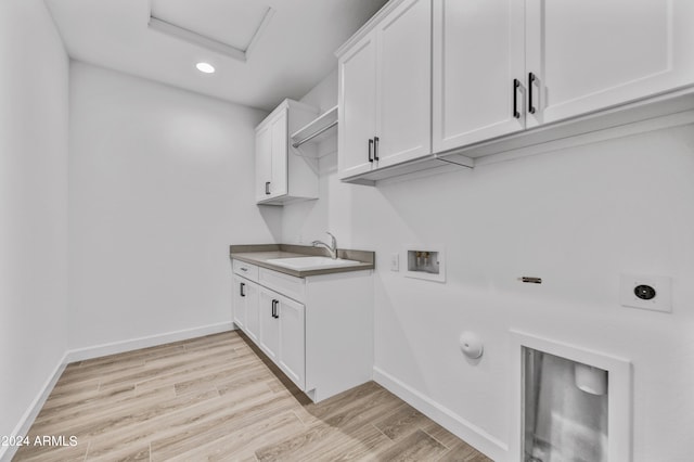 clothes washing area with washer hookup, light wood-type flooring, hookup for an electric dryer, and sink