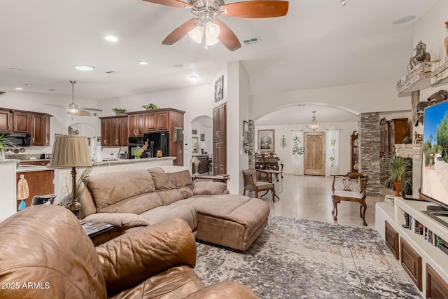 12837 N 68th St, Scottsdale, AZ 85254 - living room featuring a ceiling fan, arched walkways, and recessed lighting