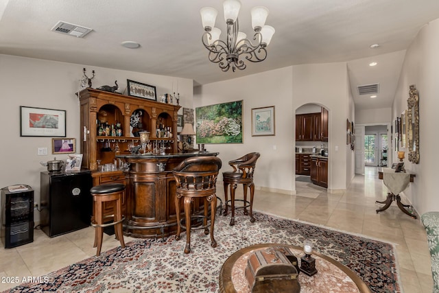 12837 N 68th St, Scottsdale, AZ 85254 - indoor dry bar with arched walkways, a chandelier, light tile patterned floors, baseboards, and recessed lighting