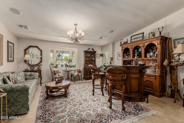 12837 N 68th St, Scottsdale, AZ 85254 - living room with a chandelier, a textured ceiling, and a bar