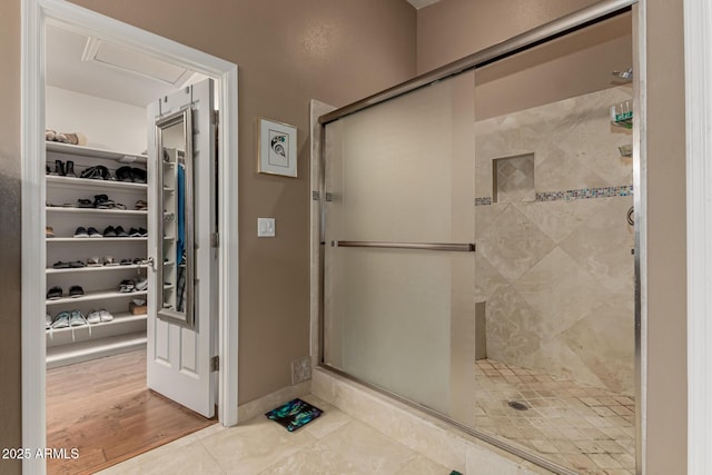 12837 N 68th St, Scottsdale, AZ 85254 - bathroom featuring a stall shower, a spacious closet, and tile patterned floors