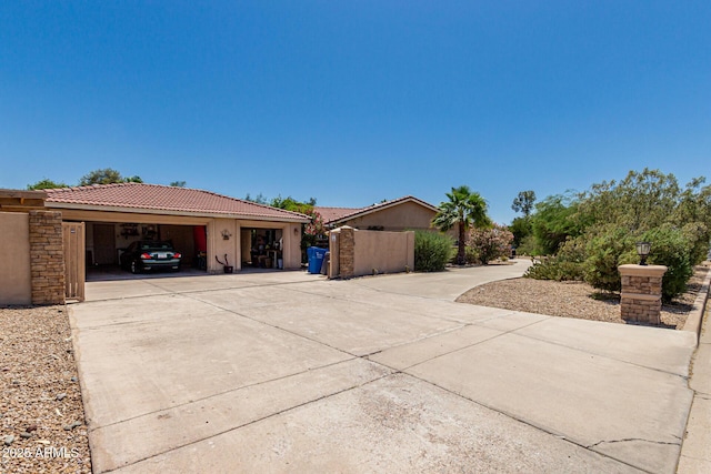 12837 N 68th St, Scottsdale, AZ 85254 - view of home's exterior featuring concrete driveway, a tiled roof, stucco siding, and a garage