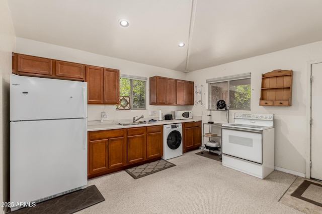 12837 N 68th St, Scottsdale, AZ 85254 - kitchen with white appliances, washer / clothes dryer, a sink, light countertops, and vaulted ceiling
