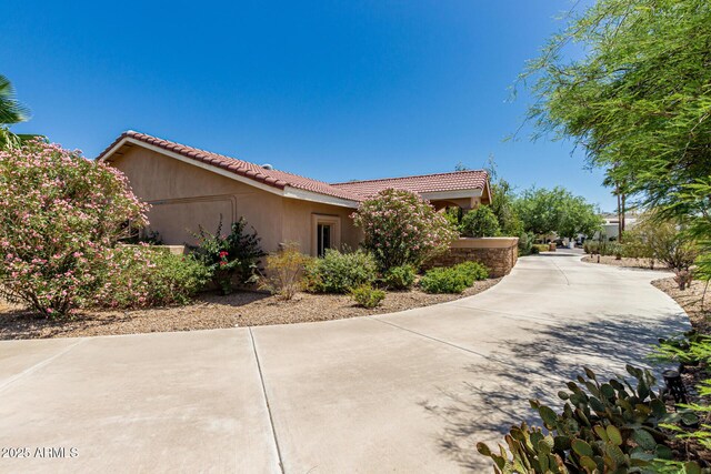 12837 N 68th St, Scottsdale, AZ 85254 - view of property exterior featuring a tile roof and stucco siding