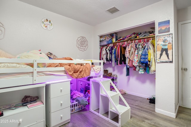 8730 E Barataria Blvd, Sierra Vista, AZ 85650 - bedroom featuring wood finished floors, baseboards, and a closet