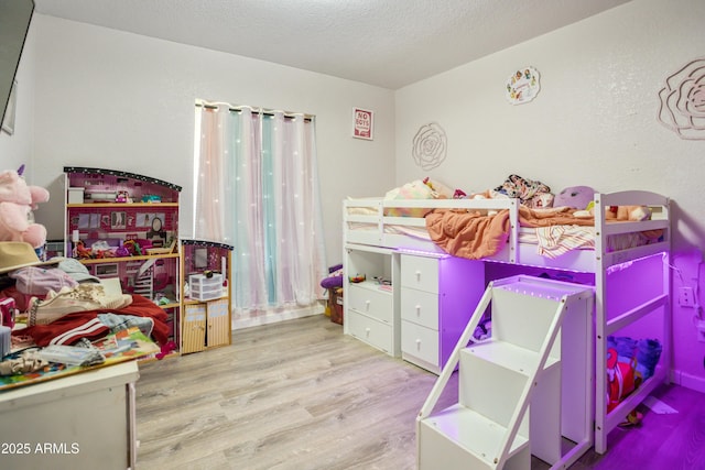 8730 E Barataria Blvd, Sierra Vista, AZ 85650 - bedroom featuring wood finished floors and a textured ceiling