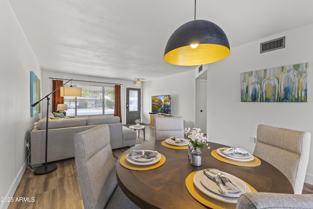 dining space featuring dark hardwood / wood-style flooring