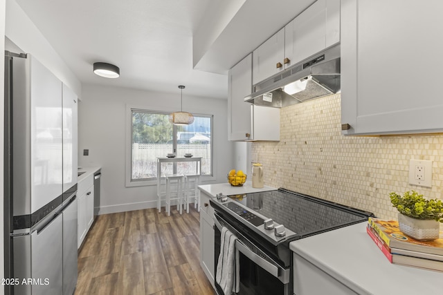 kitchen with white cabinetry, appliances with stainless steel finishes, dark hardwood / wood-style flooring, pendant lighting, and decorative backsplash