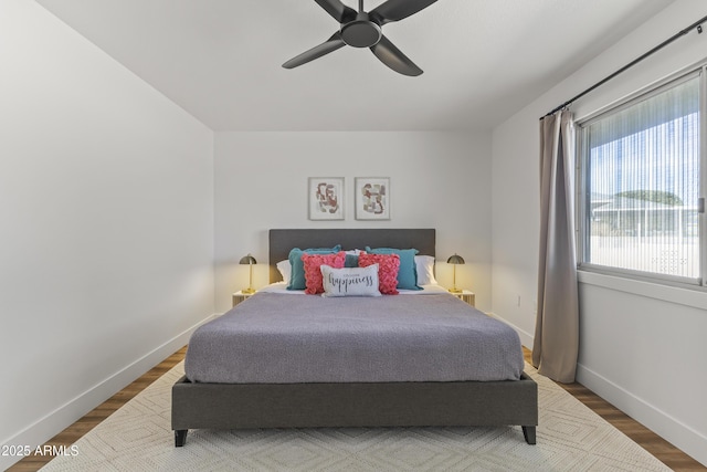 bedroom with ceiling fan and wood-type flooring