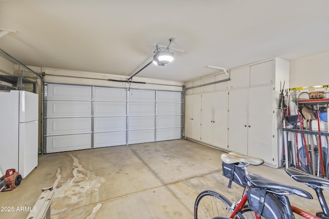 garage with a garage door opener and white fridge