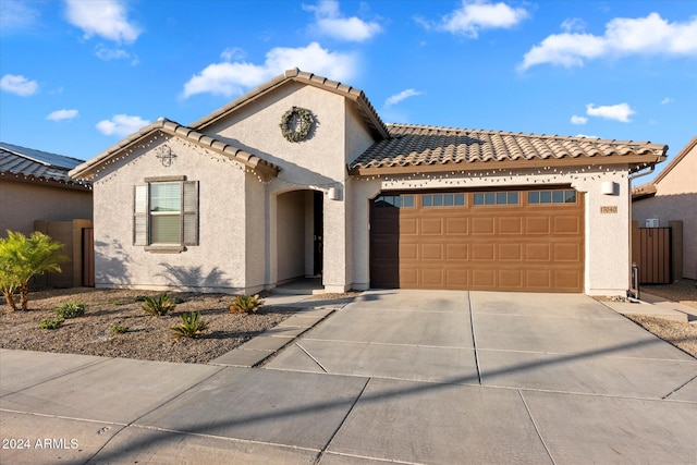 mediterranean / spanish-style home with a garage