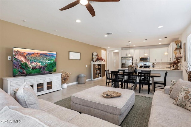 tiled living room featuring ceiling fan