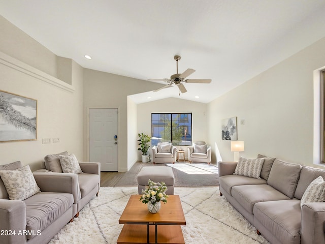 living room featuring ceiling fan, light wood-type flooring, and lofted ceiling