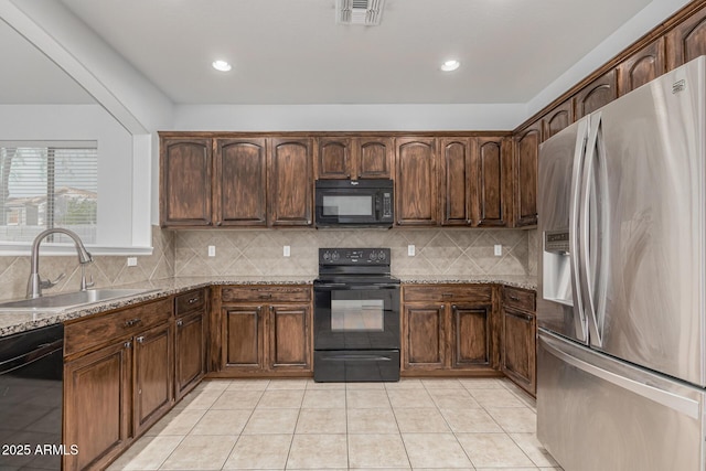 28232 N Abby Cir, San Tan Valley, AZ 85143 - kitchen featuring black appliances, a sink, backsplash, light tile patterned floors, and light stone counters