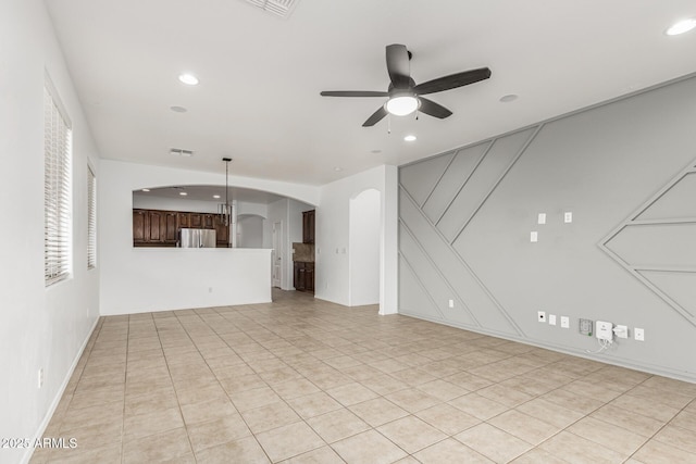 28232 N Abby Cir, San Tan Valley, AZ 85143 - unfurnished living room featuring arched walkways, ceiling fan, recessed lighting, and light tile patterned floors