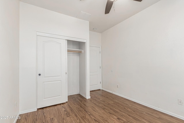 28232 N Abby Cir, San Tan Valley, AZ 85143 - unfurnished bedroom featuring wood finished floors, a closet, baseboards, and ceiling fan