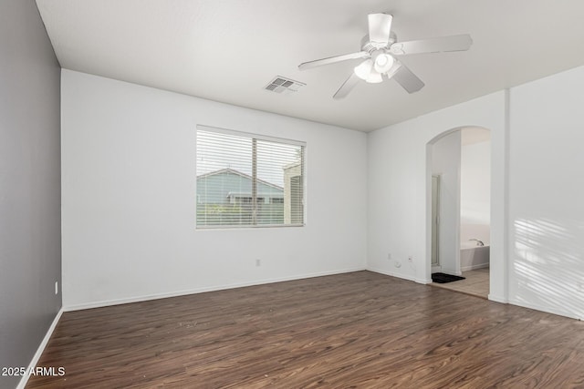 28232 N Abby Cir, San Tan Valley, AZ 85143 - unfurnished room with arched walkways, wood finished floors, ceiling fan, and baseboards