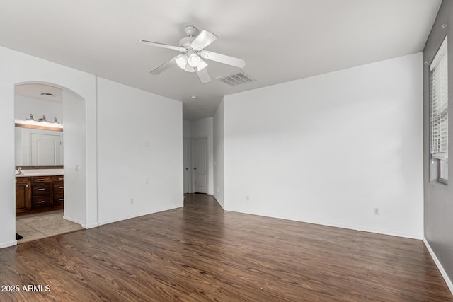 28232 N Abby Cir, San Tan Valley, AZ 85143 - spare room with wood finished floors, a ceiling fan, arched walkways, and baseboards