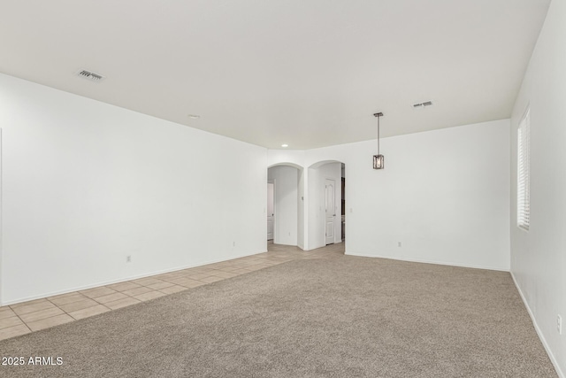 28232 N Abby Cir, San Tan Valley, AZ 85143 - empty room with arched walkways, light colored carpet, light tile patterned floors, and baseboards