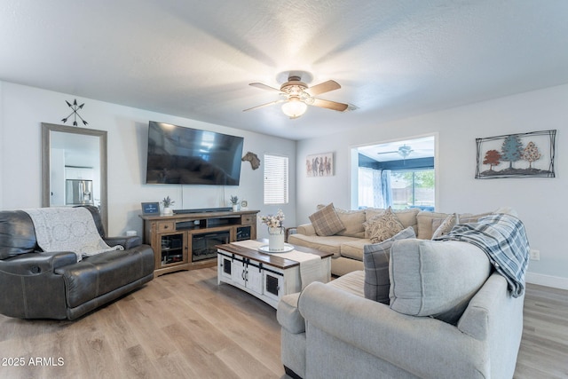 21188 N Duncan Dr, Maricopa, AZ 85138 - living room with ceiling fan, light wood finished floors, and baseboards