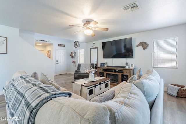 21188 N Duncan Dr, Maricopa, AZ 85138 - living room featuring light wood finished floors, ceiling fan, and baseboards