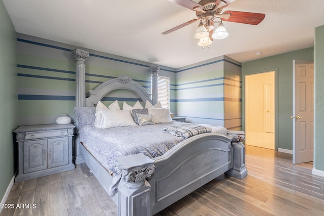 21188 N Duncan Dr, Maricopa, AZ 85138 - bedroom with wood finished floors, baseboards, and ceiling fan