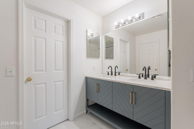 21188 N Duncan Dr, Maricopa, AZ 85138 - full bathroom with marble finish flooring, double vanity, and baseboards