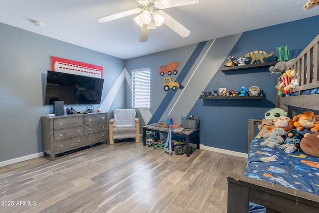 21188 N Duncan Dr, Maricopa, AZ 85138 - bedroom with wood finished floors, ceiling fan, and baseboards