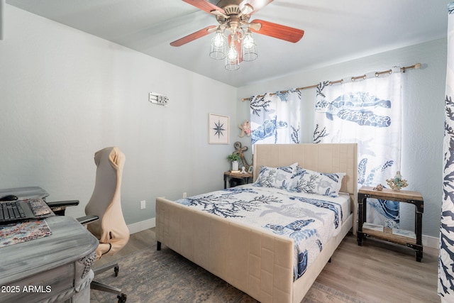 21188 N Duncan Dr, Maricopa, AZ 85138 - bedroom with wood finished floors, baseboards, and ceiling fan