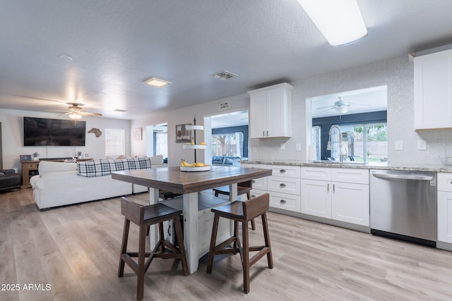 21188 N Duncan Dr, Maricopa, AZ 85138 - kitchen featuring dishwasher, a ceiling fan, a sink, light wood-style flooring, and a textured ceiling
