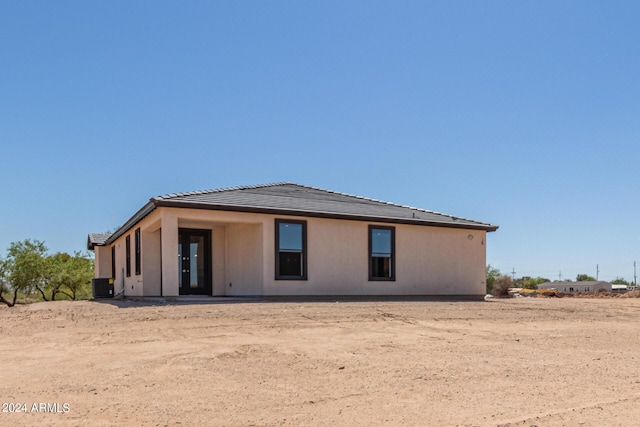 rear view of property featuring central AC unit