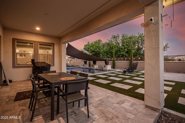 view of patio / terrace with a fenced in pool, outdoor dining area, and fence