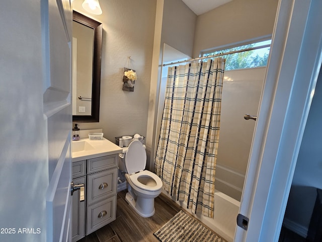 bathroom featuring toilet, shower / bath combo, wood finished floors, and vanity