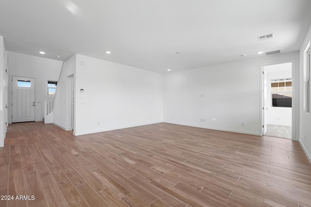 unfurnished room featuring a wealth of natural light and light hardwood / wood-style flooring