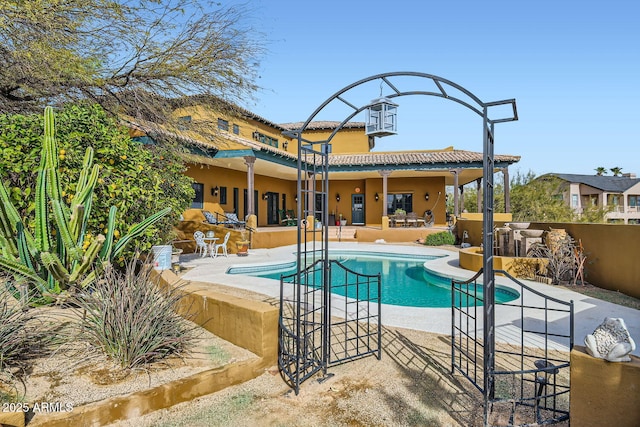 view of swimming pool featuring a bar and a patio area