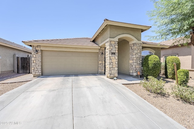 2717 W Bowker St, Phoenix, AZ 85041 - view of front facade with driveway, a garage, stucco siding, a tile roof, and stone siding