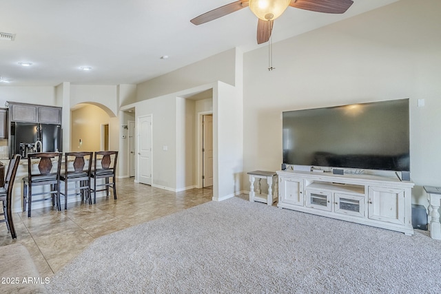 2717 W Bowker St, Phoenix, AZ 85041 - living area featuring arched walkways, ceiling fan, light tile patterned flooring, light carpet, and lofted ceiling