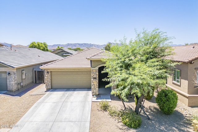 2717 W Bowker St, Phoenix, AZ 85041 - view of front facade with driveway, an attached garage, stucco siding, a tiled roof, and stone siding