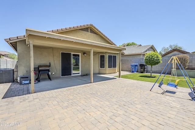 2717 W Bowker St, Phoenix, AZ 85041 - rear view of property featuring a fenced backyard, a patio area, stucco siding, and a playground