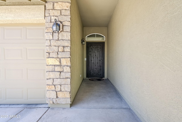 2717 W Bowker St, Phoenix, AZ 85041 - entrance to property featuring a garage, stone siding, and stucco siding