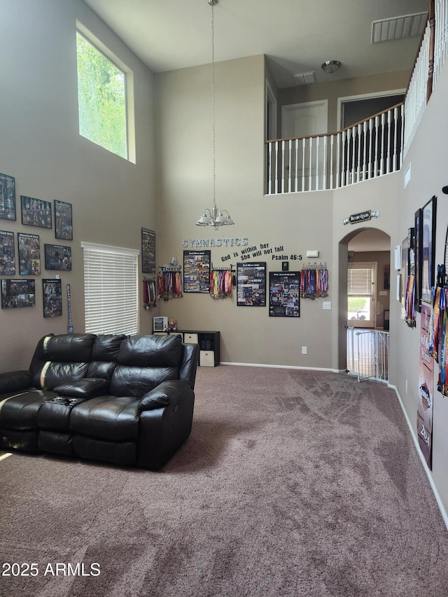 21280 N 96th Ave, Peoria, AZ 85382 - living area featuring a towering ceiling, carpet flooring, arched walkways, and a chandelier