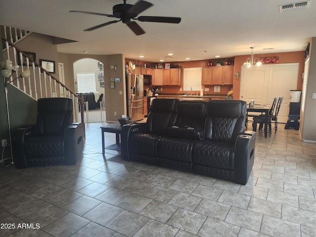 21280 N 96th Ave, Peoria, AZ 85382 - living room with a ceiling fan, stairway, arched walkways, and healthy amount of natural light