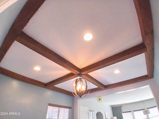 details featuring beam ceiling and a chandelier