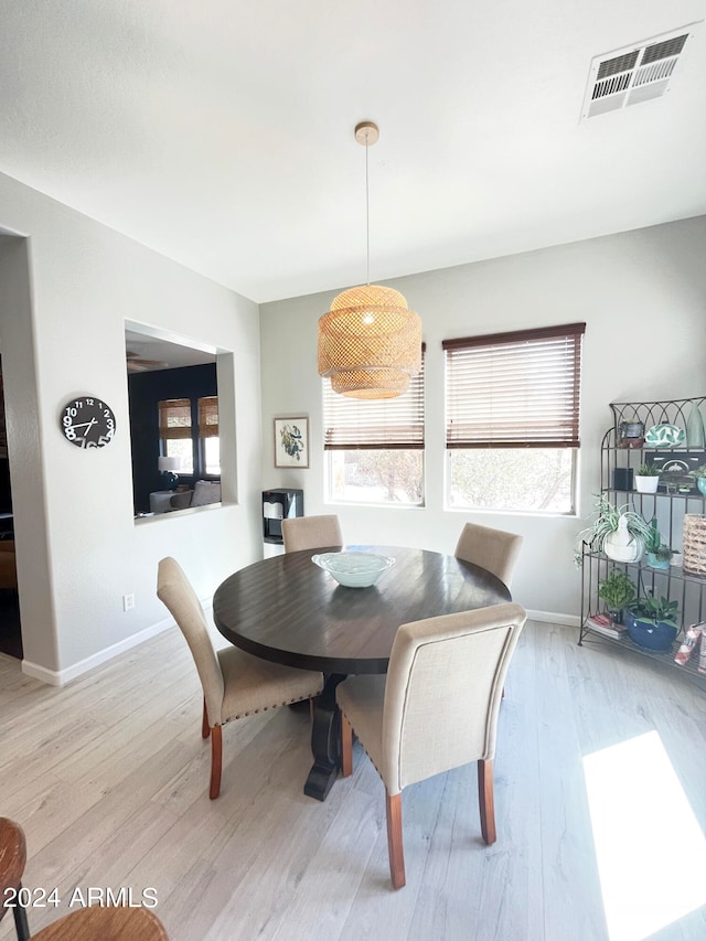 dining space featuring light wood-type flooring and plenty of natural light