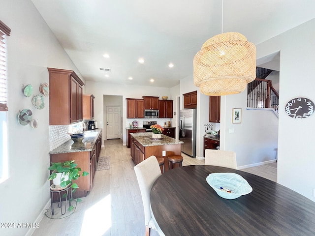 dining area with sink and light hardwood / wood-style floors