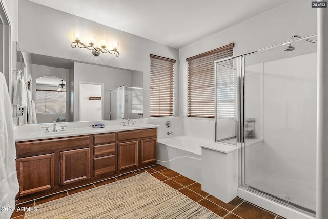 bathroom with tile patterned flooring, ceiling fan, vanity, and separate shower and tub