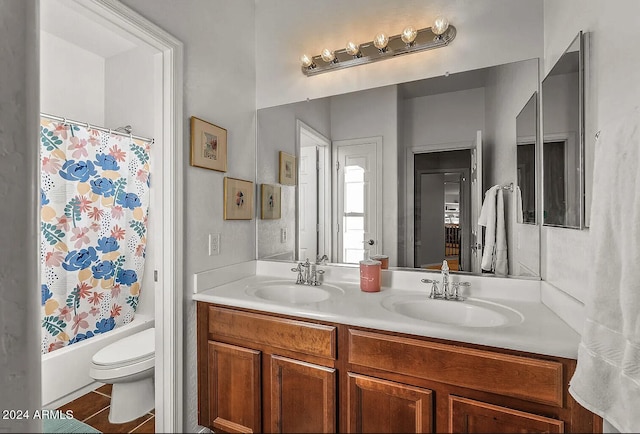 full bathroom with shower / tub combo with curtain, tile patterned flooring, vanity, and toilet