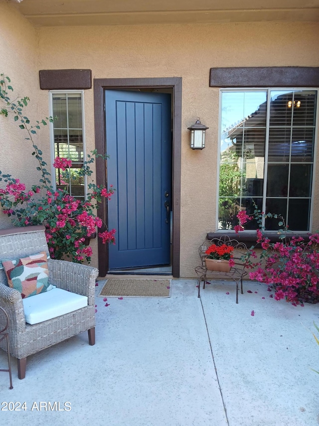 entrance to property featuring a patio