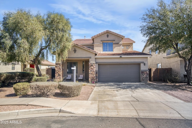 mediterranean / spanish house featuring a garage, concrete driveway, a tiled roof, and stucco siding