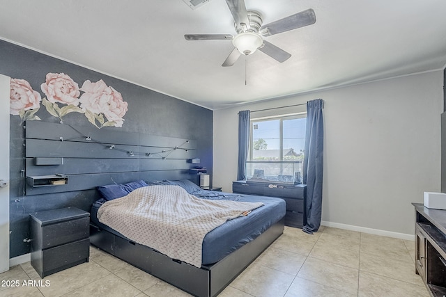 tiled bedroom featuring a ceiling fan and baseboards